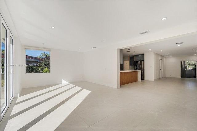 unfurnished living room with a healthy amount of sunlight