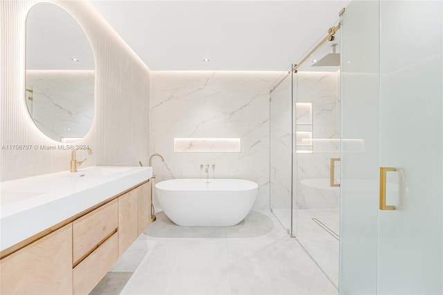 bathroom with vanity, tile walls, and independent shower and bath