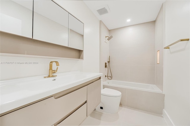 full bathroom featuring tile patterned flooring, vanity, tiled shower / bath combo, and toilet