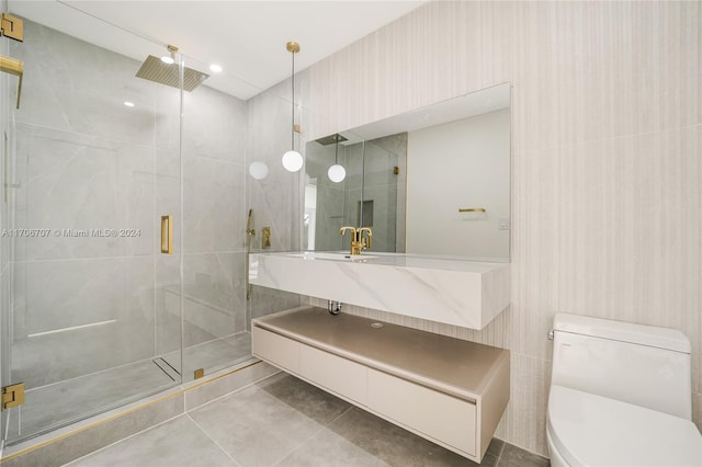 bathroom featuring tile patterned flooring, vanity, toilet, and walk in shower