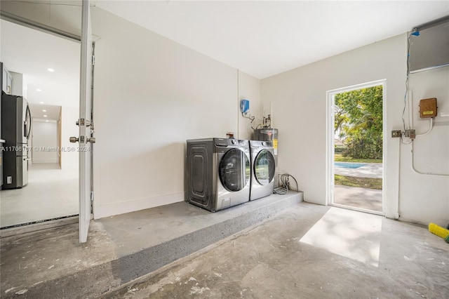 laundry room with water heater and washing machine and clothes dryer