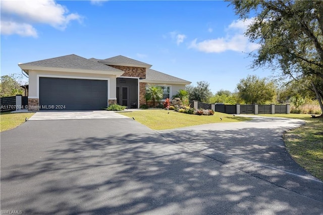 view of front of house with a front yard and a garage