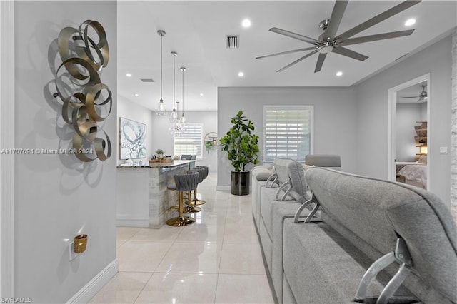 living room featuring ceiling fan and light tile patterned floors