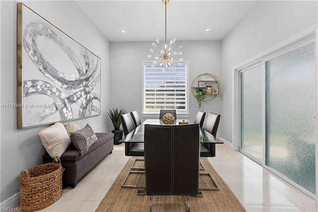 dining space with a chandelier and light tile patterned floors