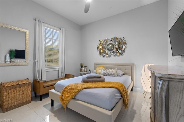 tiled bedroom featuring ceiling fan