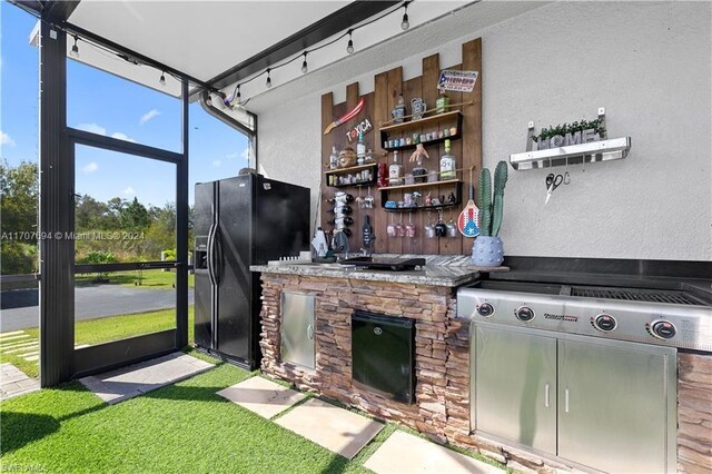 kitchen featuring black fridge with ice dispenser