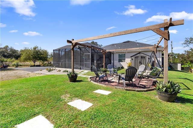 view of yard featuring a fire pit and a lanai