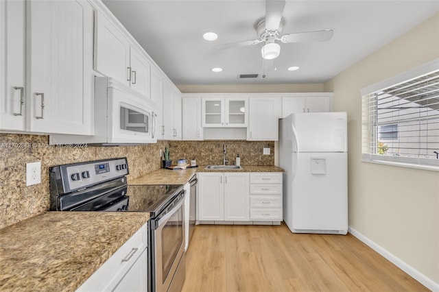 kitchen featuring appliances with stainless steel finishes, light wood-type flooring, ceiling fan, sink, and white cabinetry