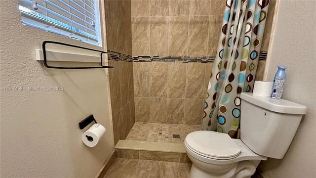 bathroom with toilet and tile patterned flooring