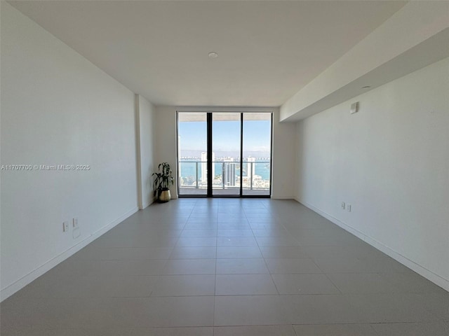 tiled empty room with floor to ceiling windows