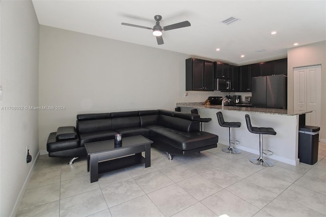 tiled living room featuring ceiling fan