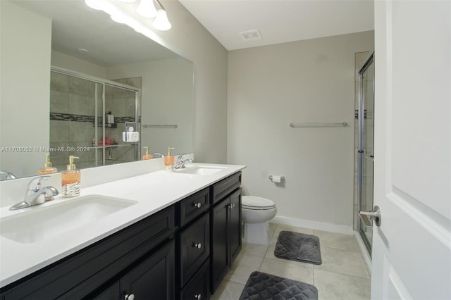 bathroom featuring tile patterned floors, vanity, toilet, and an enclosed shower