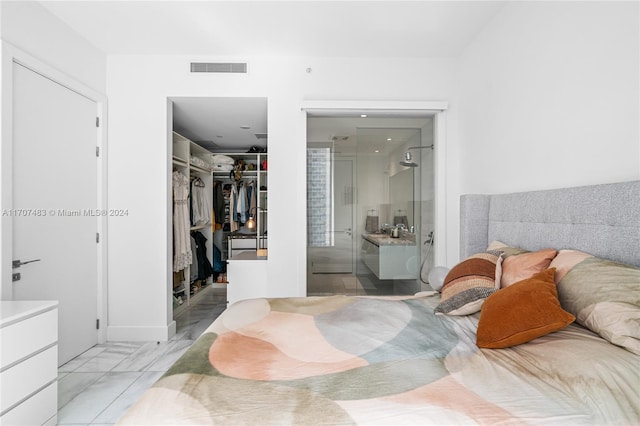 bedroom featuring ensuite bathroom and a closet