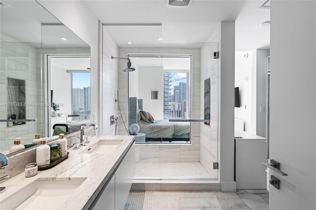 bathroom featuring plenty of natural light, vanity, and a shower with door