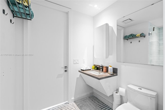 bathroom with tile patterned flooring, toilet, and sink