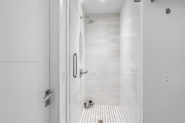 bathroom featuring a shower with shower door