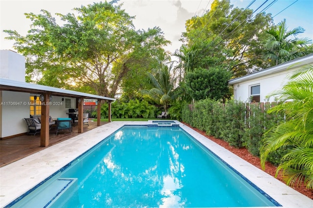 view of pool featuring an in ground hot tub and a wooden deck