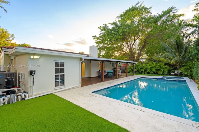 view of pool featuring an in ground hot tub and a patio