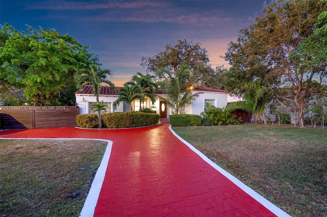 mediterranean / spanish house featuring a lawn