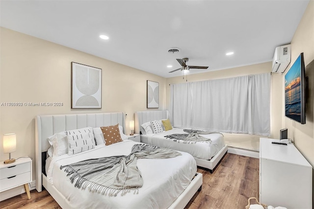 bedroom with hardwood / wood-style flooring, ceiling fan, and an AC wall unit