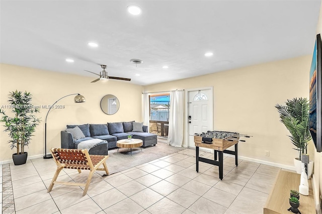 living room with ceiling fan and light tile patterned floors