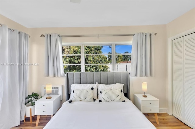 bedroom with wood-type flooring and a closet