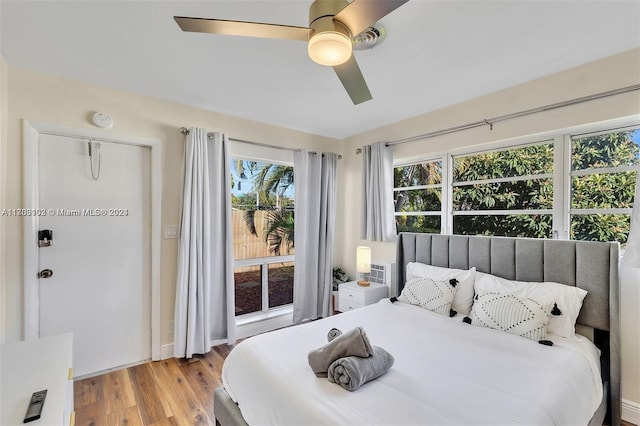 bedroom with light hardwood / wood-style floors and ceiling fan