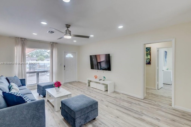 living room featuring ceiling fan and light wood-type flooring