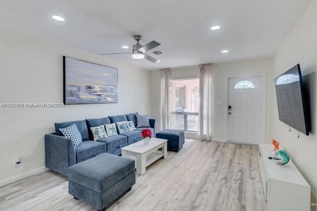 living room with ceiling fan and light hardwood / wood-style floors