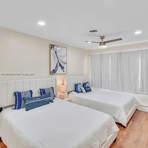 bedroom featuring hardwood / wood-style floors and ceiling fan