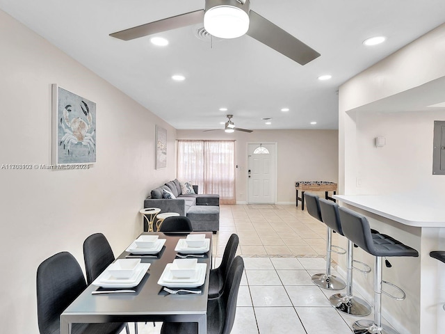 dining space featuring electric panel, ceiling fan, and light tile patterned flooring