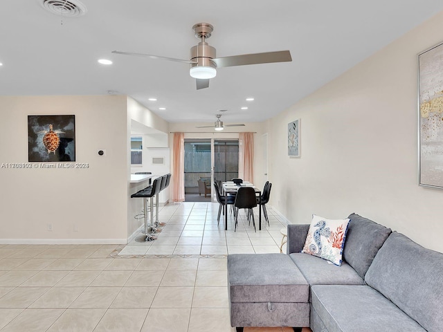 tiled living room with ceiling fan