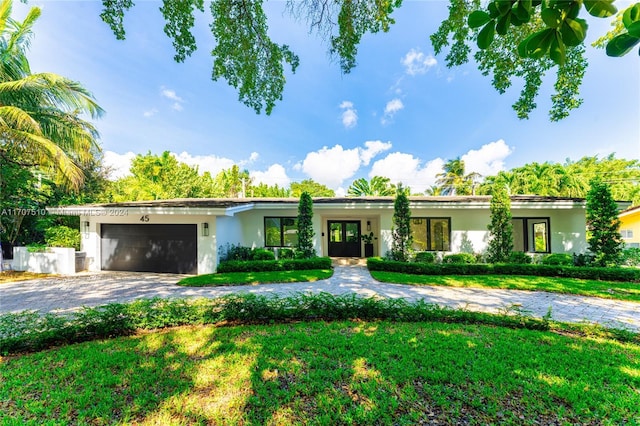 view of front of property with a garage and a front yard