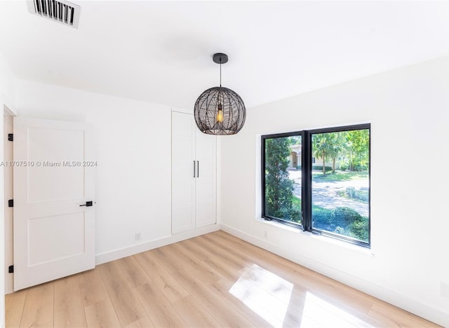 empty room with hardwood / wood-style flooring