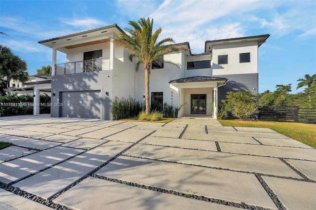 6401 SW 84th St, South Miami, FL 33143 - contemporary house with french doors, a balcony, a garage, stucco siding, and concrete driveway