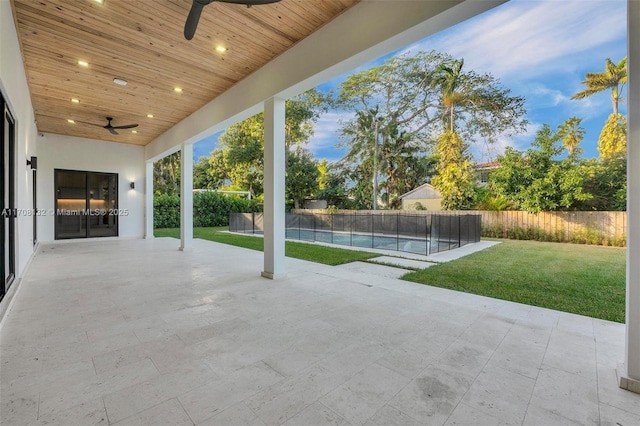 6401 SW 84th St, South Miami, FL 33143 - fenced backyard with a ceiling fan and a patio area