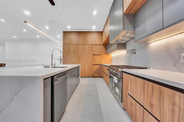 6401 SW 84th St, South Miami, FL 33143 - kitchen with modern cabinets, stainless steel appliances, light stone countertops, wall chimney exhaust hood, and recessed lighting