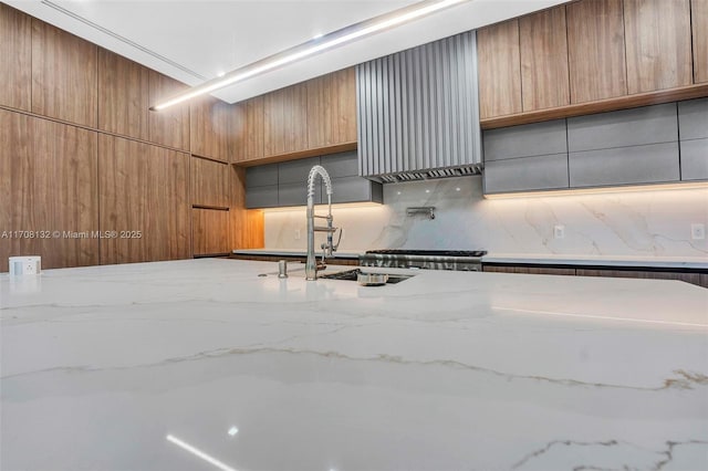 6401 SW 84th St, South Miami, FL 33143 - kitchen featuring backsplash, light stone counters, and modern cabinets