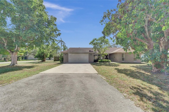 ranch-style home featuring a garage and a front lawn