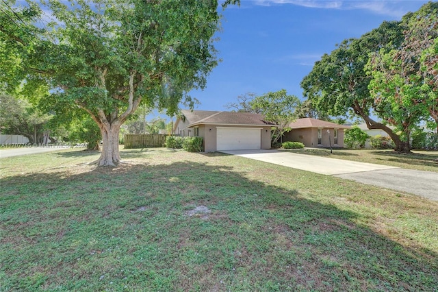 single story home with a garage and a front lawn