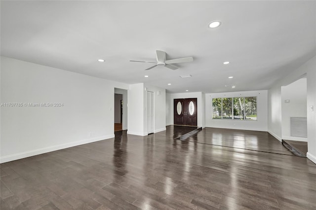 unfurnished living room featuring ceiling fan and dark hardwood / wood-style floors