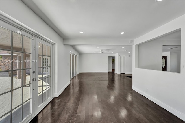 empty room with ceiling fan, dark hardwood / wood-style flooring, and french doors