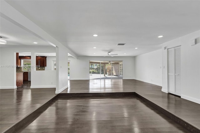 empty room featuring ceiling fan and dark hardwood / wood-style floors