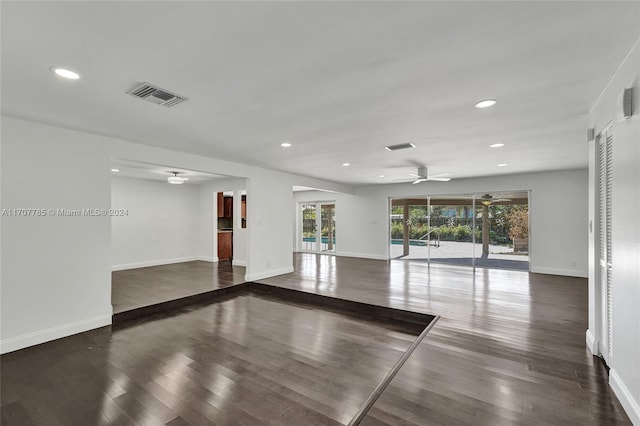 empty room with dark hardwood / wood-style flooring and ceiling fan