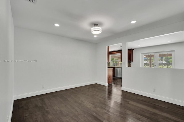 empty room with french doors and dark wood-type flooring