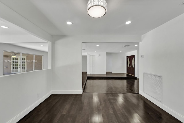 empty room with dark hardwood / wood-style flooring