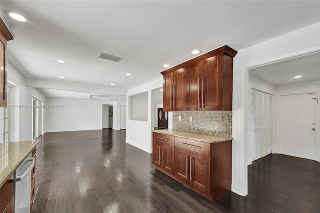 kitchen with light stone countertops, tasteful backsplash, ceiling fan, dark wood-type flooring, and dishwasher