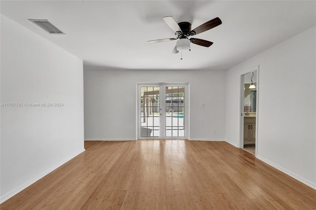 unfurnished room featuring ceiling fan, french doors, and light hardwood / wood-style floors