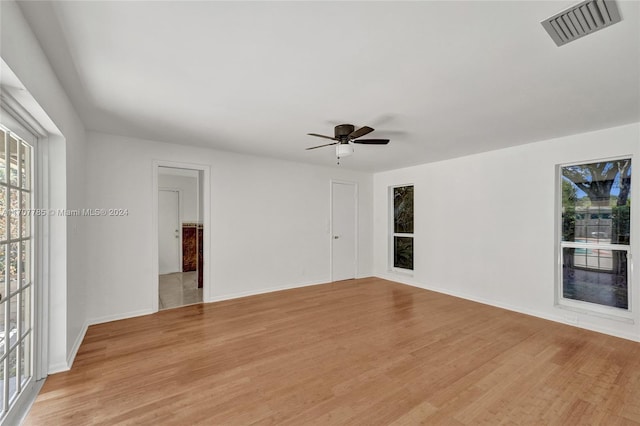 empty room with light wood-type flooring and ceiling fan