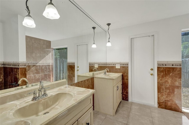 bathroom with tile patterned flooring, vanity, and tile walls